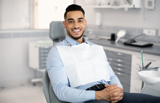 Smiling man sitting in dental chair