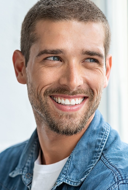 A happy, smiling man looking to the side