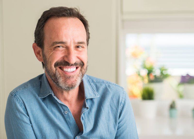 Older patient smiling with dental implants 